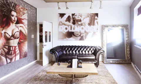 Contemporary studio space with leather seating, large-scale portrait displays and professional lighting